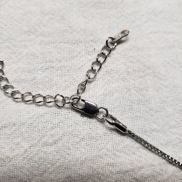 Beautiful silver tone small snake pattern necklace with a wing, a cross, bead - Picture 5 of 9